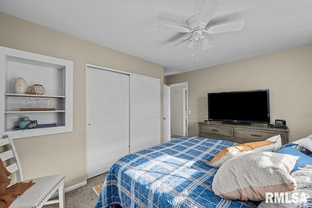 carpeted bedroom featuring a closet and ceiling fan