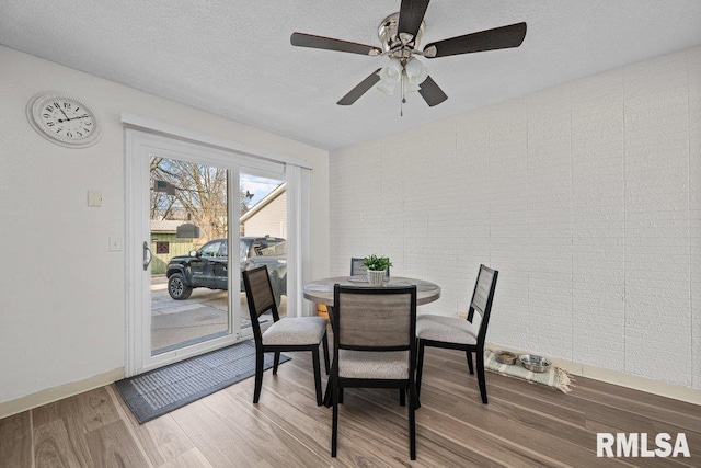 dining area featuring hardwood / wood-style floors and a textured ceiling