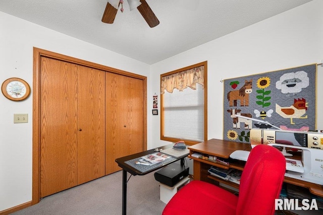 carpeted office featuring ceiling fan