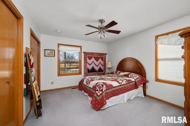 bedroom with light carpet and ceiling fan