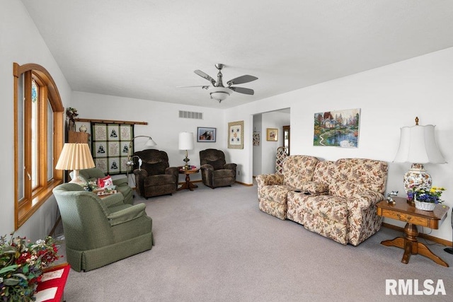 living room featuring plenty of natural light, carpet flooring, and ceiling fan