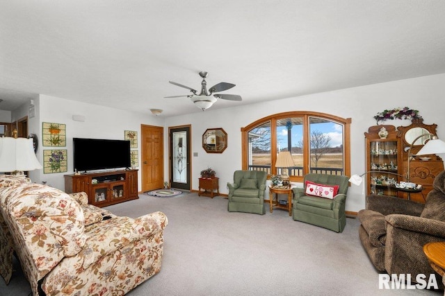 carpeted living room with ceiling fan