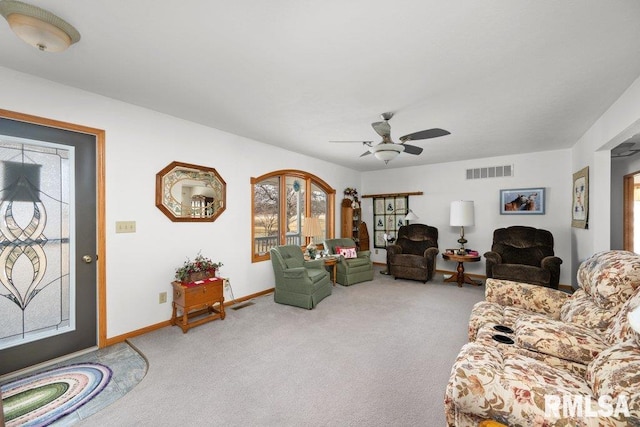 living room with ceiling fan, carpet floors, and a wealth of natural light