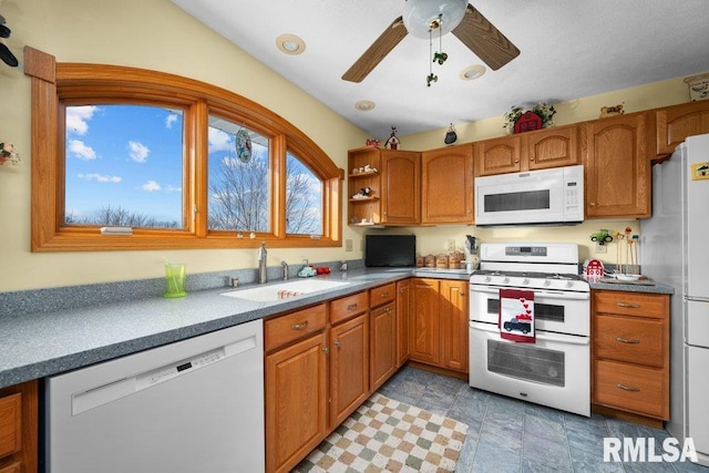 kitchen featuring ceiling fan, sink, and white appliances