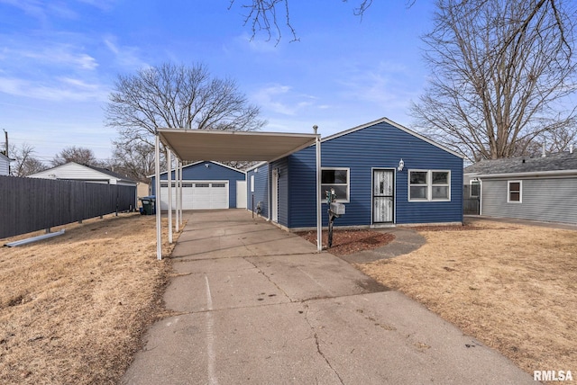 view of front facade featuring a garage, an outdoor structure, and a carport