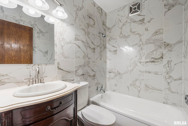 full bathroom featuring tasteful backsplash, vanity, toilet, and tub / shower combination