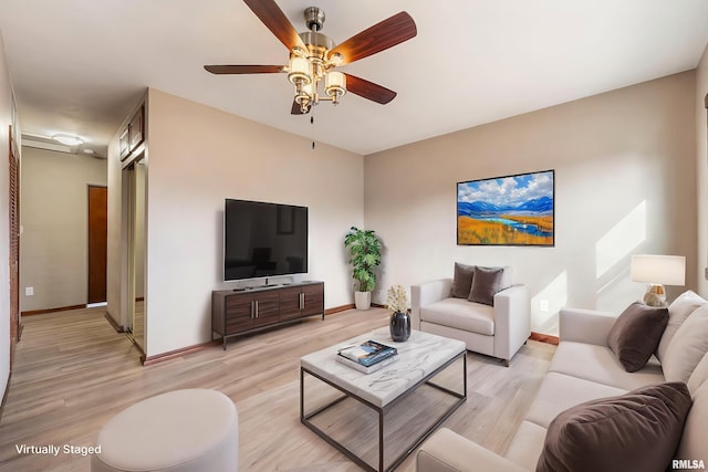 living room with ceiling fan and light wood-type flooring