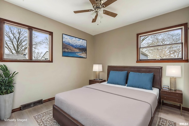 bedroom with light hardwood / wood-style floors and ceiling fan