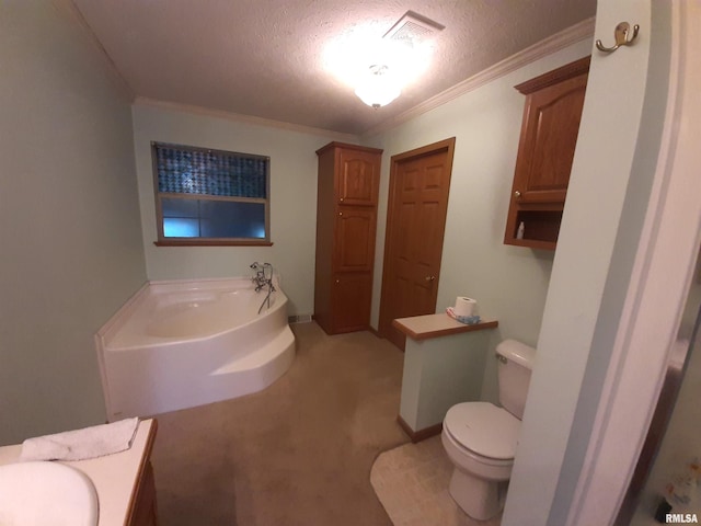 bathroom featuring vanity, ornamental molding, a textured ceiling, a tub to relax in, and toilet