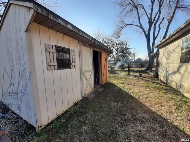 view of outbuilding featuring a lawn