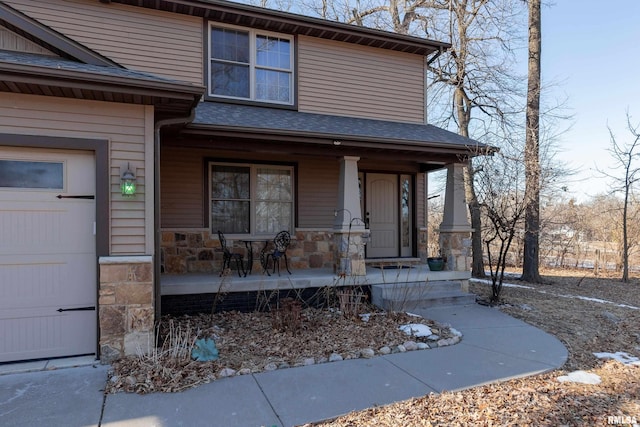 property entrance featuring an attached garage, covered porch, stone siding, and a shingled roof