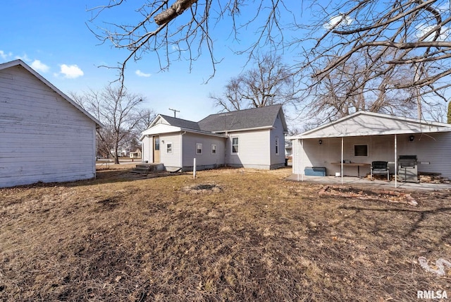 back of house featuring a patio area and a lawn