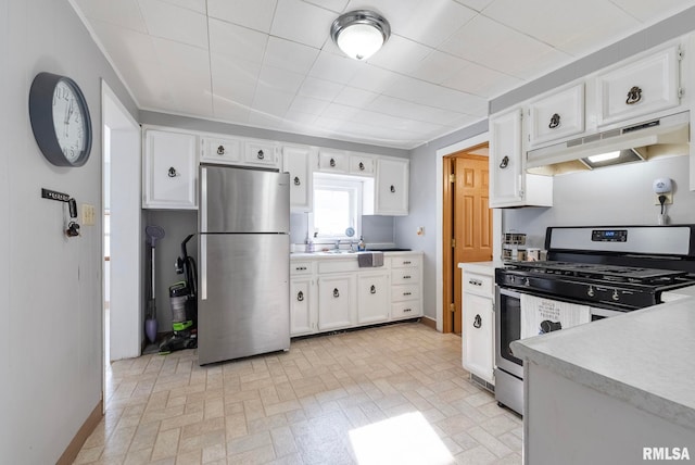 kitchen with appliances with stainless steel finishes, sink, and white cabinets