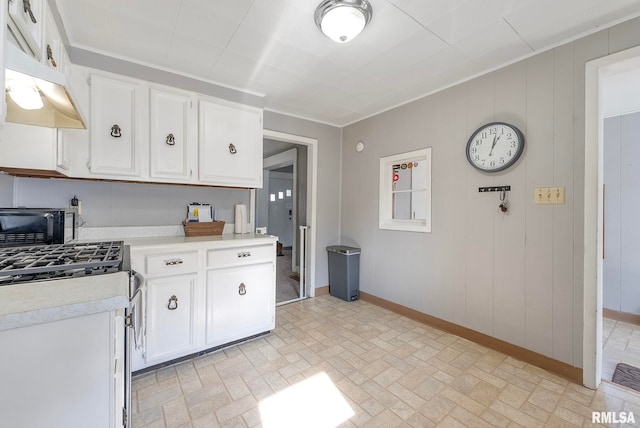 kitchen featuring white cabinetry, ornamental molding, and stainless steel range with gas cooktop