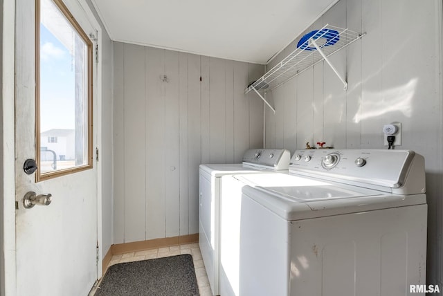 washroom with washer and dryer and light tile patterned floors