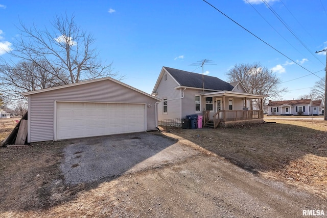 view of front of home with a porch, a garage, and an outdoor structure