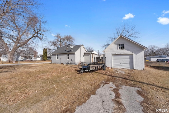 rear view of house with an outbuilding, a yard, and a garage