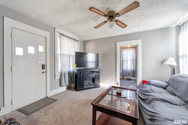 carpeted living room with ceiling fan and a healthy amount of sunlight