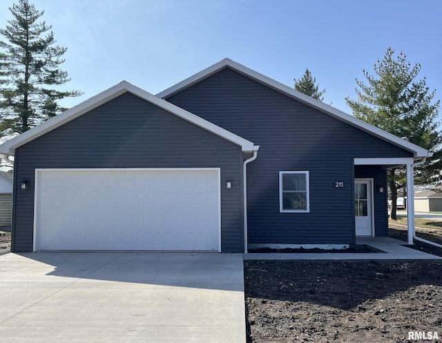ranch-style house featuring an attached garage and driveway