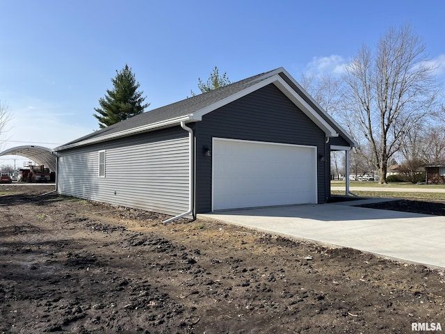 garage featuring concrete driveway