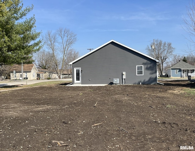 view of side of home with central air condition unit