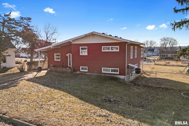 view of property exterior with a yard and fence