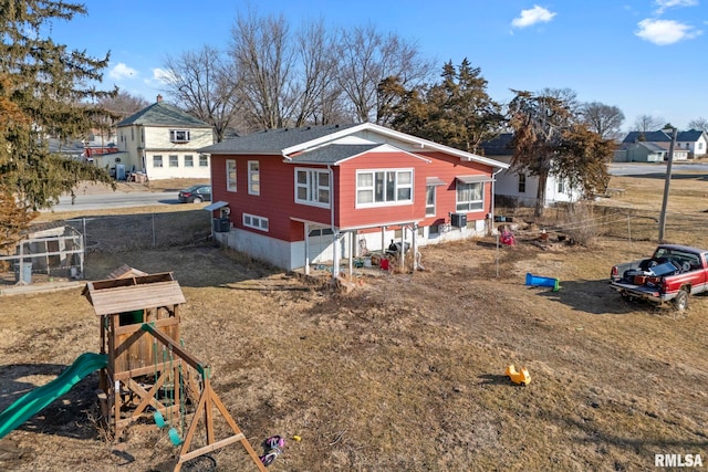 exterior space with a playground and fence