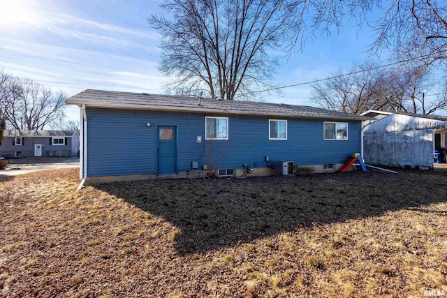 rear view of house featuring central AC unit