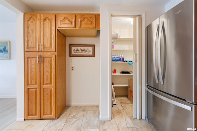 kitchen featuring stainless steel refrigerator