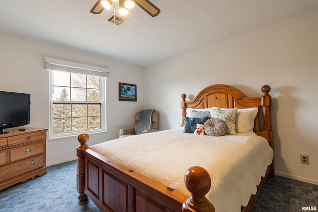 bedroom with ceiling fan and dark colored carpet