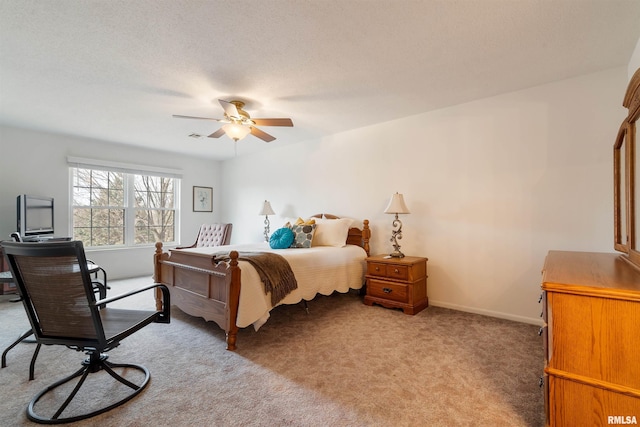 carpeted bedroom featuring ceiling fan and a textured ceiling