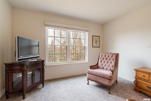 sitting room featuring light colored carpet