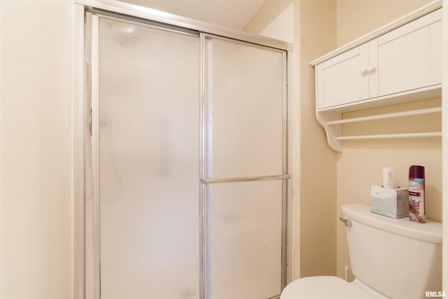 bathroom with toilet and walk in shower