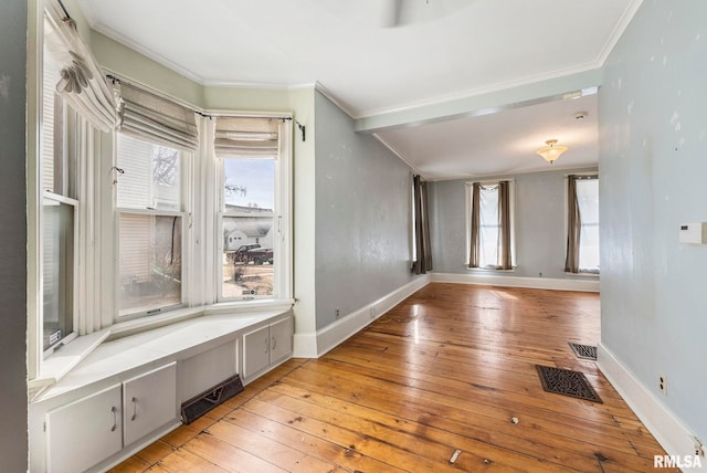 interior space with ornamental molding and light hardwood / wood-style floors