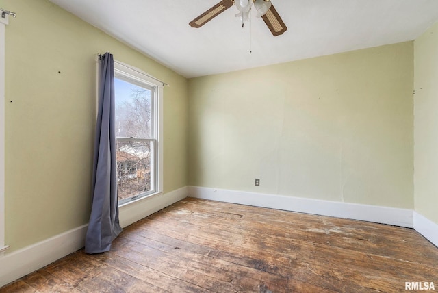 empty room with hardwood / wood-style floors and ceiling fan