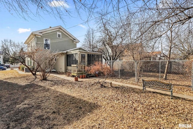 view of side of property featuring a sunroom