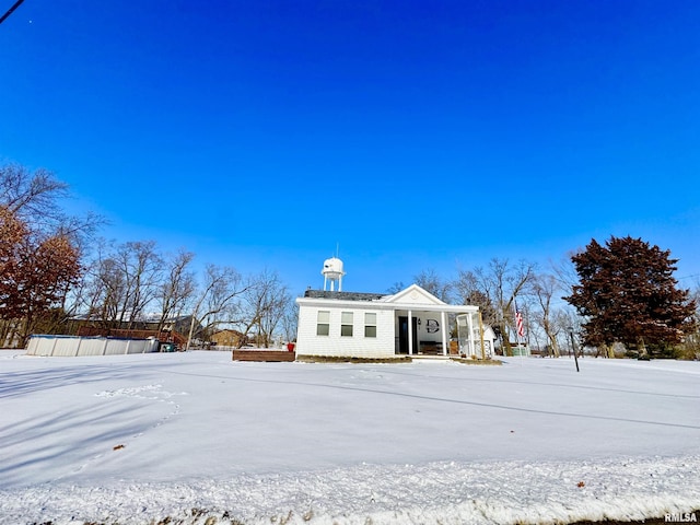 view of snow covered rear of property