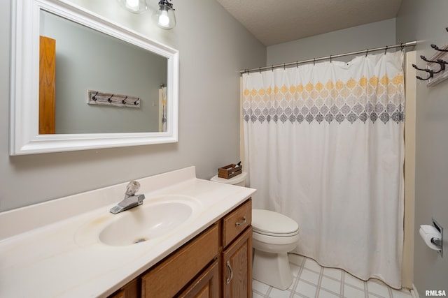 bathroom featuring vanity, curtained shower, a textured ceiling, and toilet