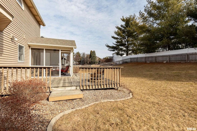 view of yard featuring a wooden deck and a sunroom