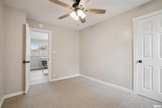 unfurnished bedroom with ceiling fan and carpet