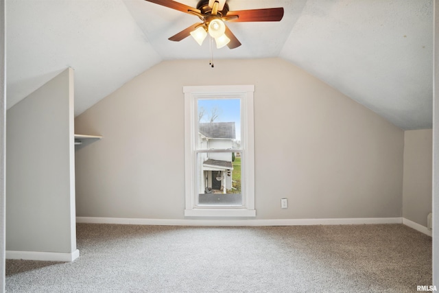 additional living space with lofted ceiling, carpet floors, and ceiling fan