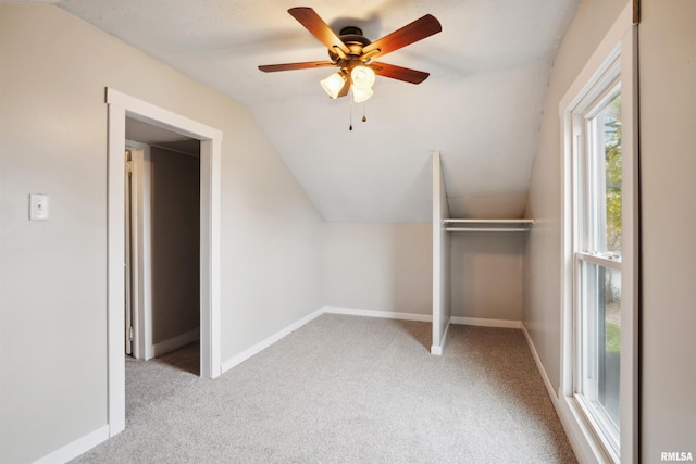 bonus room featuring ceiling fan, light colored carpet, and vaulted ceiling