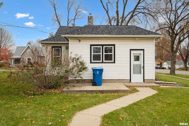 view of front facade with a patio and a front yard