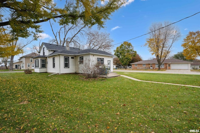 view of side of home with a lawn