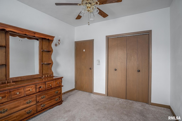 carpeted bedroom with ceiling fan and a closet