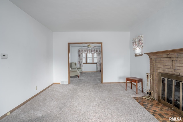 living room featuring a fireplace and carpet