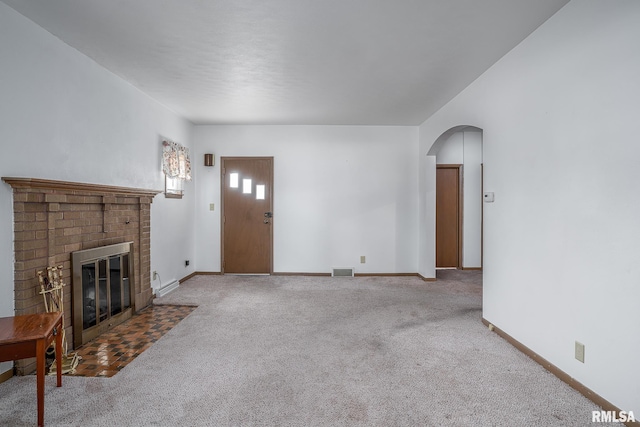 unfurnished living room featuring carpet floors and a fireplace