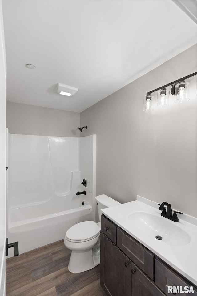 2803 N 23rd St Unit 1, Quincy, IL 62305 - bathroom featuring wood finished floors, toilet, vanity, and shower / washtub combination