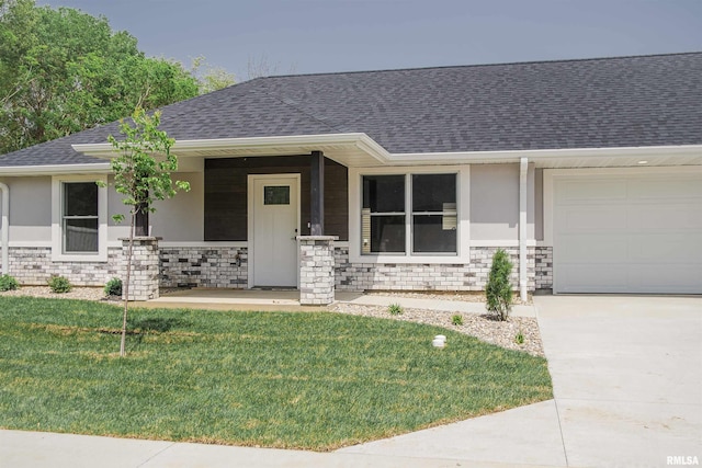 2803 N 23rd St Unit 1, Quincy, IL 62305 - view of front facade featuring an attached garage, a shingled roof, stone siding, covered porch, and a front yard