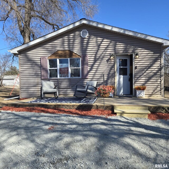 view of front of house with an outdoor structure and a wooden deck